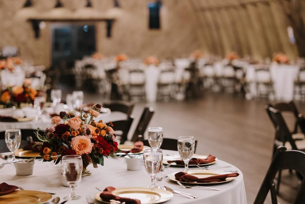 Close up of table rentals inside wedding barn reception