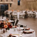 Close up of table rentals inside wedding barn reception