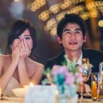 Couple listening to wedding speeches during reception
