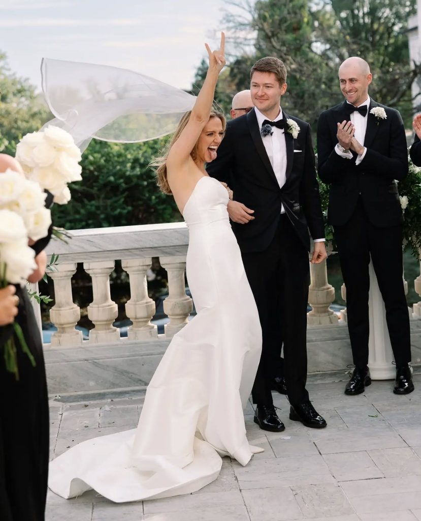 bride and groom cheering after wedding ceremony