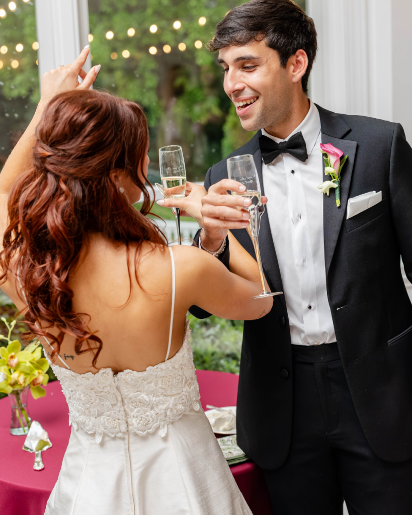 Bride and groom celebrating with champagne during their wedding reception at The Grande Victorian in Charlotte, NC.
