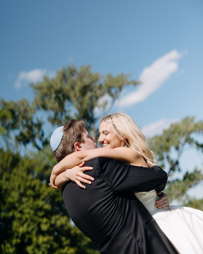 groom twirling bride while smiling after wedding reception at outdoor northern virginia wedding venue
