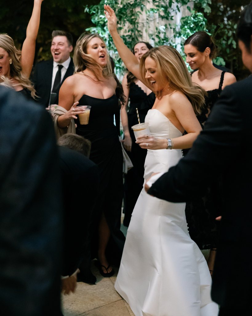 bride dancing with guest at outdoor wedding reception dance floor