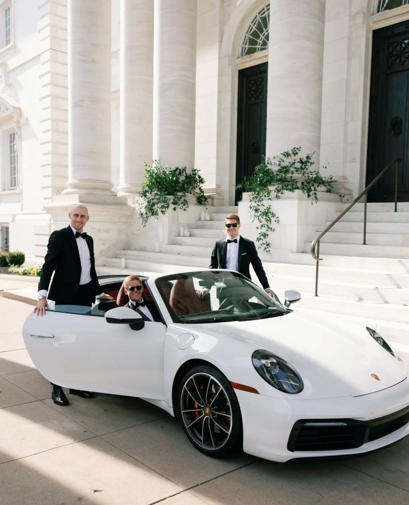 groom and groomsmen sitting in luxury car outside of wedding ceremony