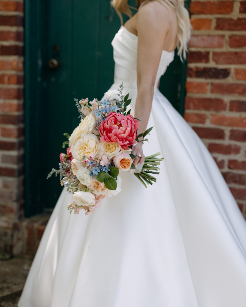 bride carrying pastel colorful wedding bouquet