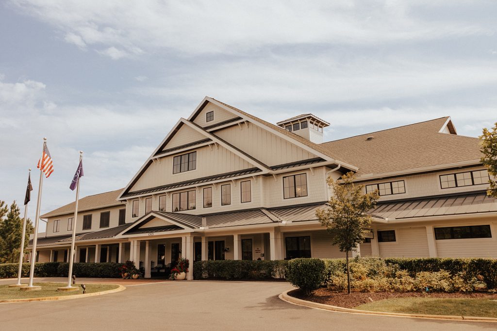 Exterior of Bayside Resort Golf Club in Selbyville, Delaware on wedding day with coastal-style clubhouse architecture