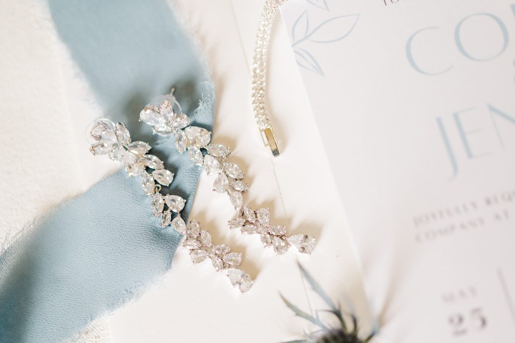 Close-up detail of pearl bridal jewelry and wedding stationery photographed before the Delaware wedding day.