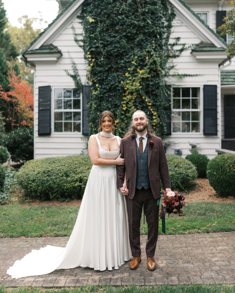 Bride and groom portrait in front of the ivy covered exterior of The Morehead Inn during a romantic Charlotte wedding.