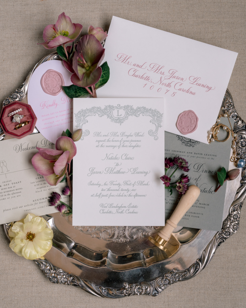 Elegant wedding invitation suite with pink wax seals, vintage silver tray styling, and pastel spring florals.