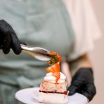 Columbus wedding dessert vendor adding strawberry filling to a freshly prepared shortcake at an interactive reception dessert station.