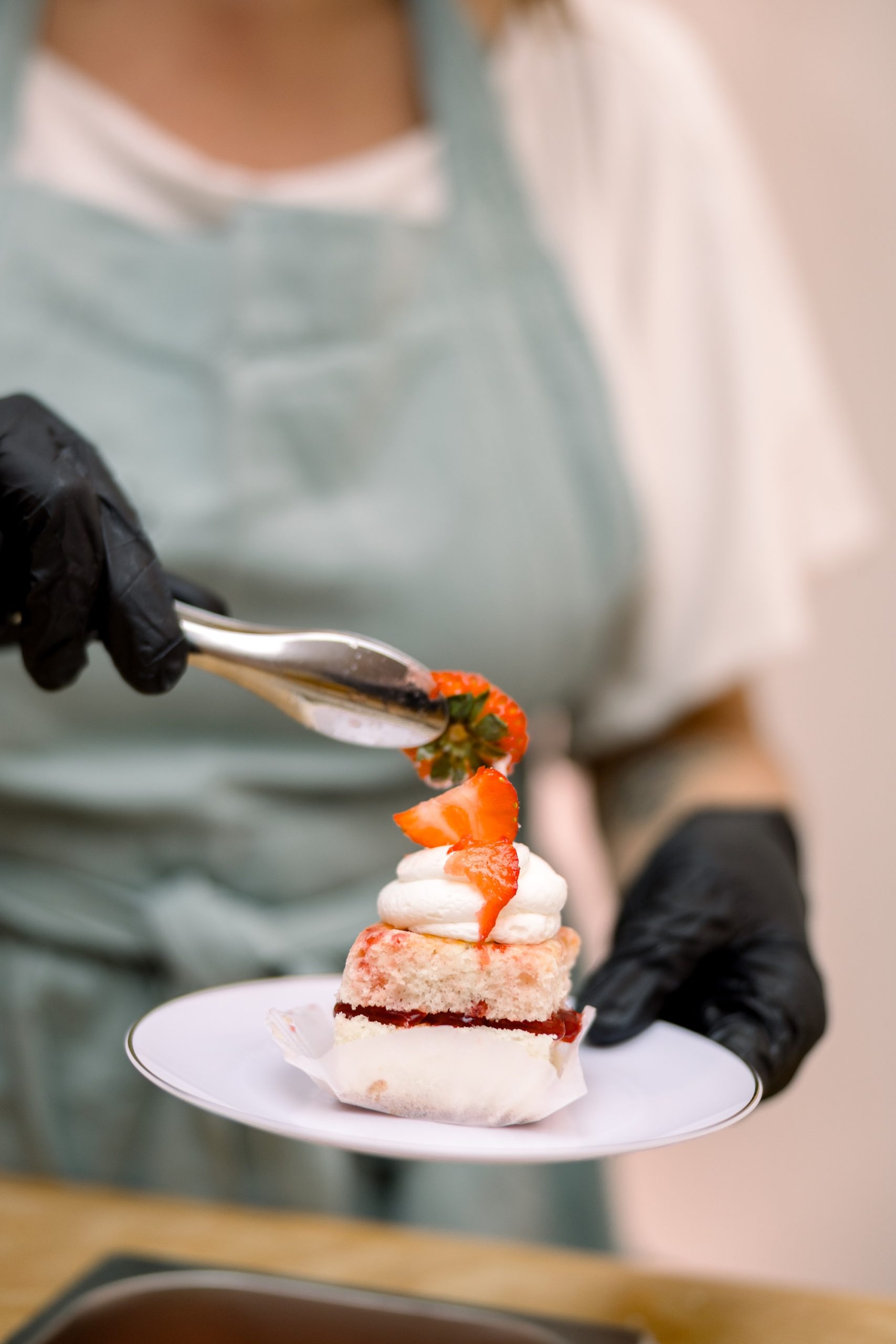Columbus wedding dessert vendor adding strawberry filling to a freshly prepared shortcake at an interactive reception dessert station.