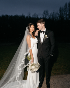 Bride and groom in modern black tie attire posing outdoors at The Lumen House in Cleveland North Carolina at night with dramatic lighting