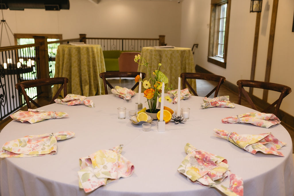 Table scape with blue linens and coloful napkins from Nuage Design. Florals from Serendipity Floral Design. Designed by AJcoordinates.