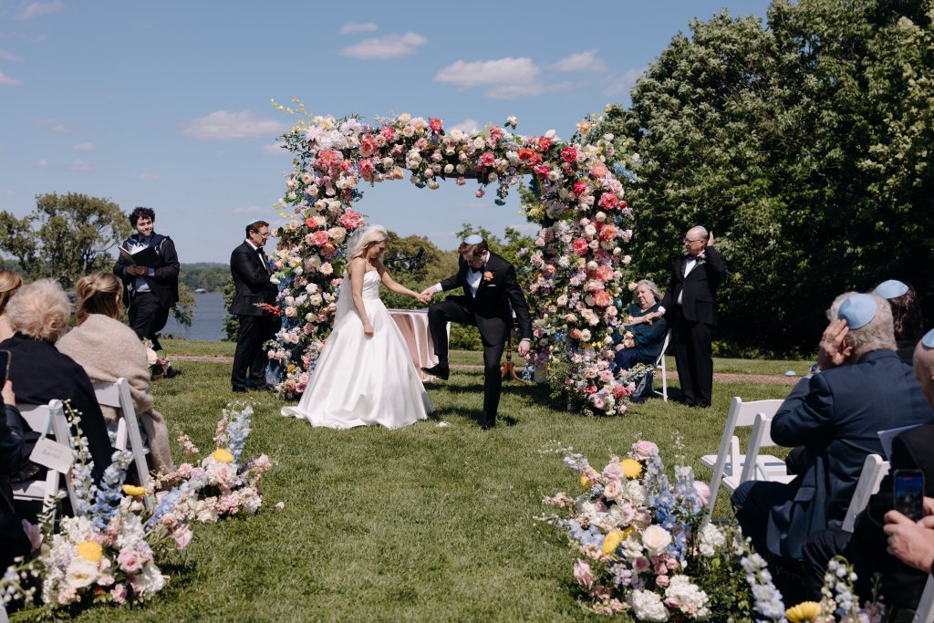 groom breaking glass jewish tradition outside wedding ceremony
