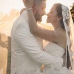 bride holding groom face outdoor golden hour photography