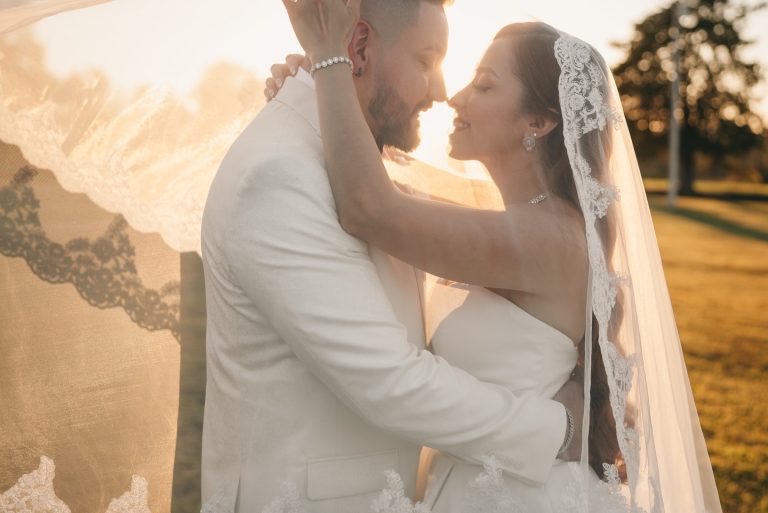 bride holding groom face outdoor golden hour photography