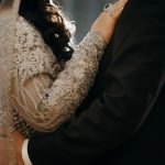 Close up detail photo of bride and groom embracing