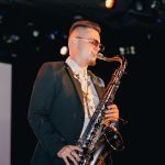 man playing saxophone at event