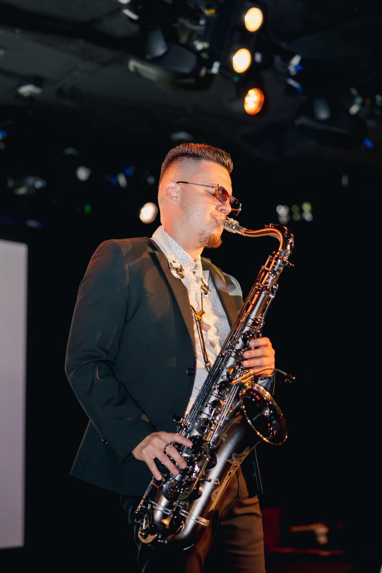 man playing saxophone at event