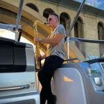 man playing sax on yacht