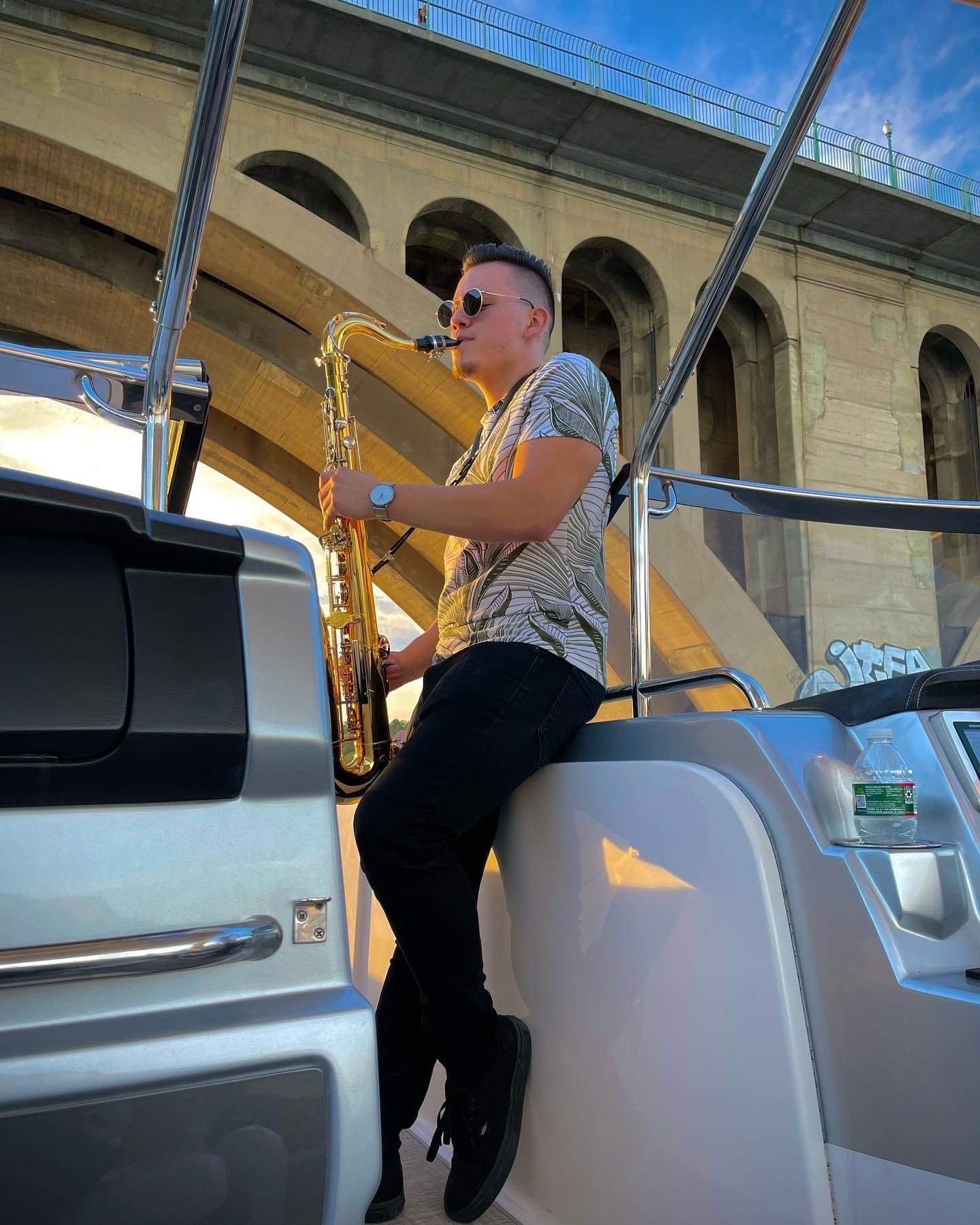 man playing sax on yacht