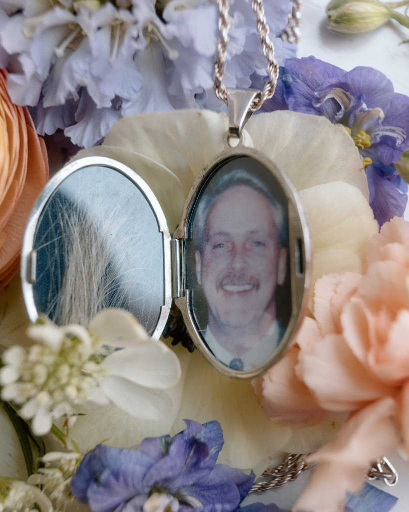 close up of wedding bouquet with charm of deceased father