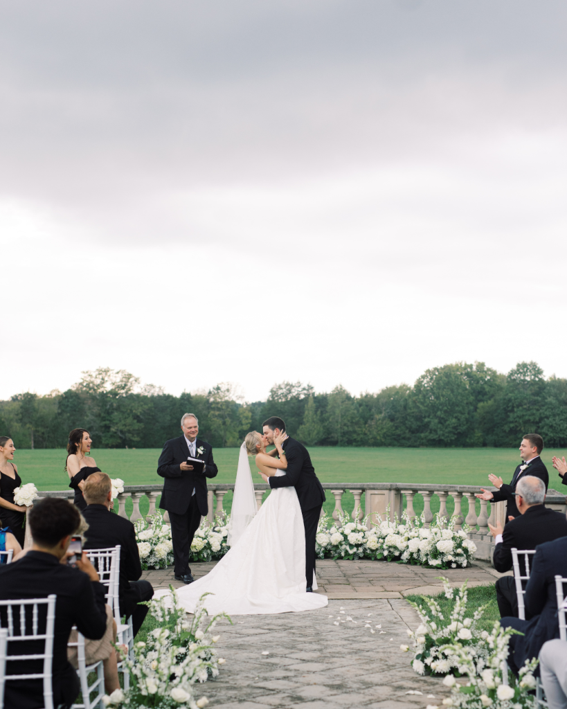 first kiss as husband and wife wedding ceremony at outdoor mansion wedding