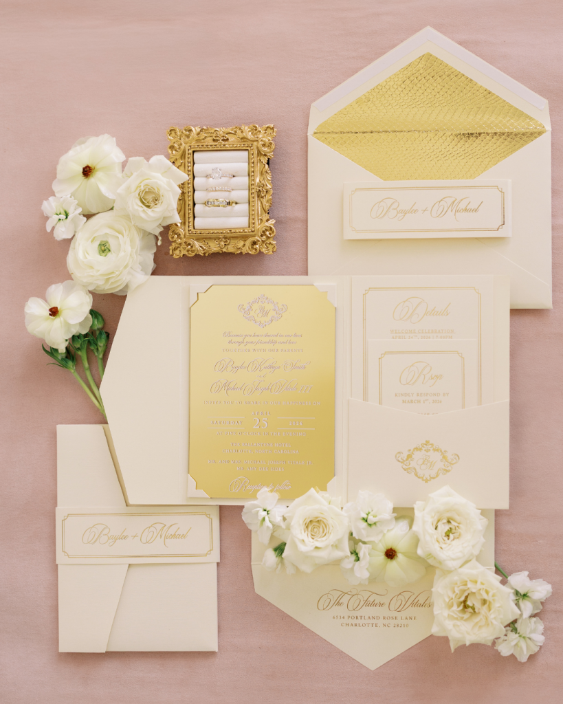 Elegant gold foil wedding invitation suite with cream paper and floral styling photographed for a Charlotte wedding.