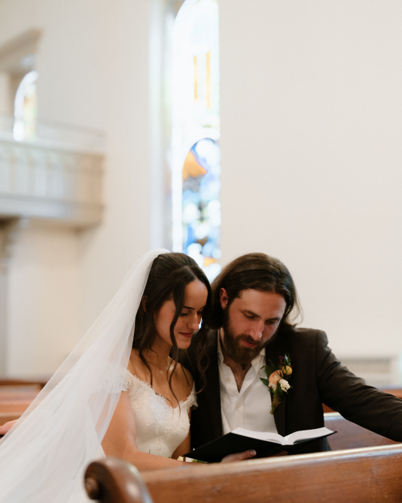 bride and groom reading bible in childhood church in northern virginia