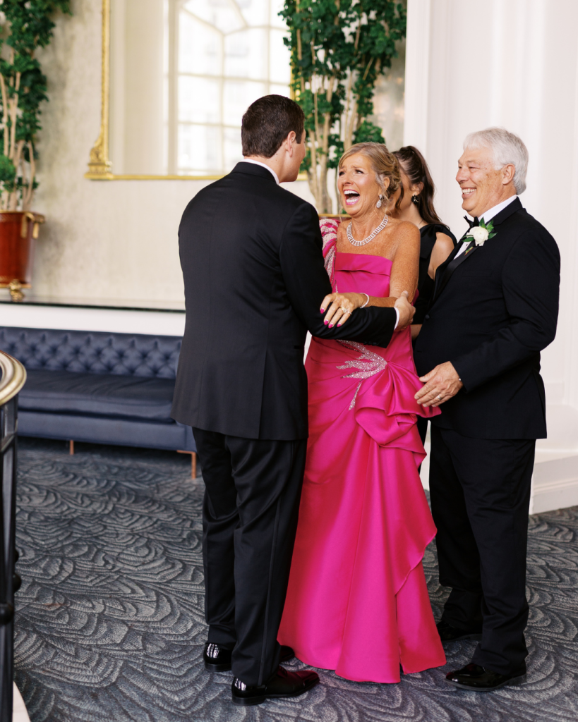 Groom shares an emotional moment with his parents before the wedding reception.