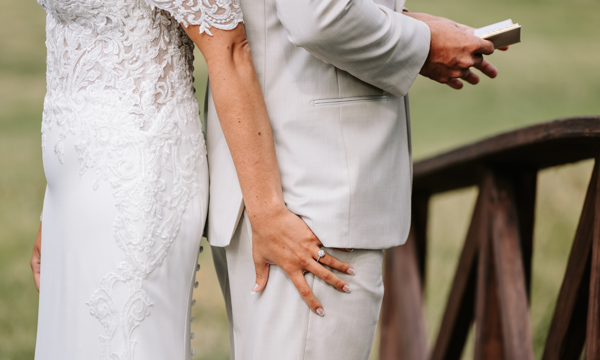 Bride and groom holding hands during a private first touch before their wedding ceremony.