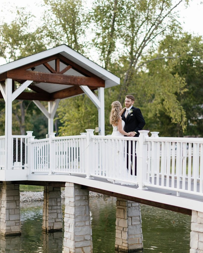 Bride and groom crossing a bridge at Knotting Hills Wedding Venue & Resort.