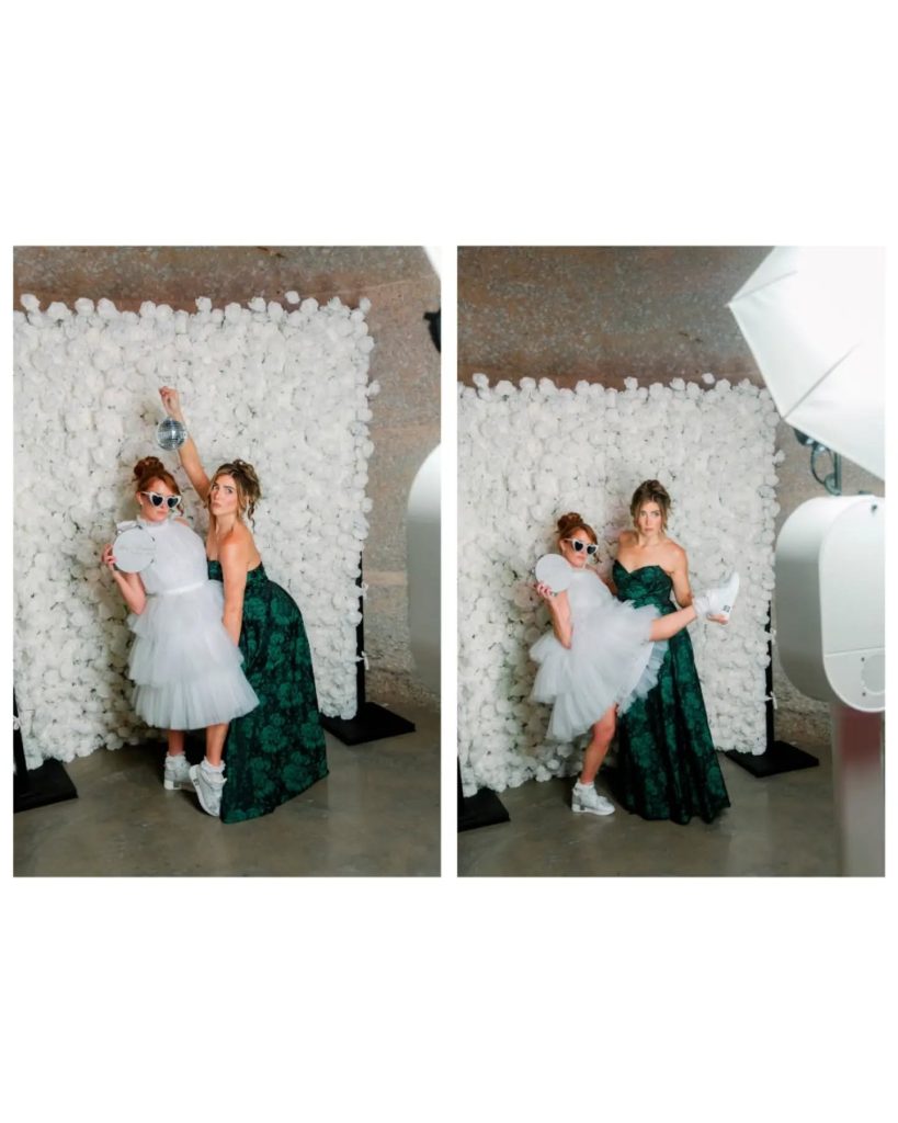 bride and bridesmaid at photobooth celebrating together