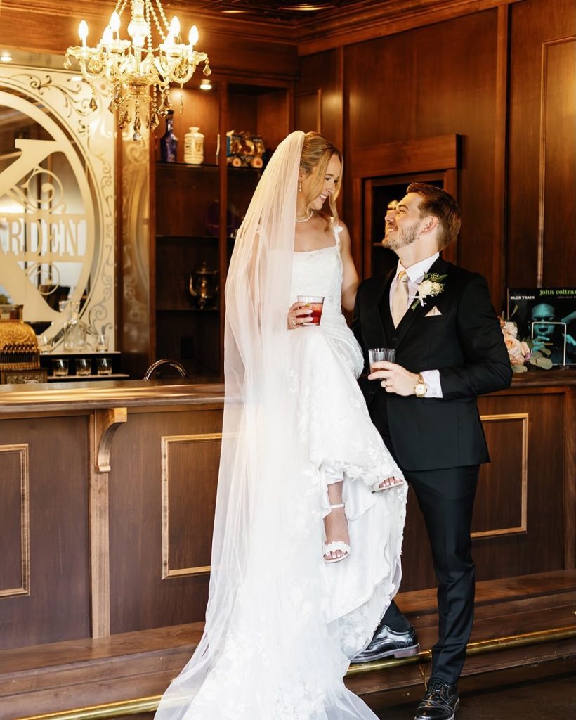 Bride and groom posing at the inside bar at Knotting Hills Wedding Venue & Resort.