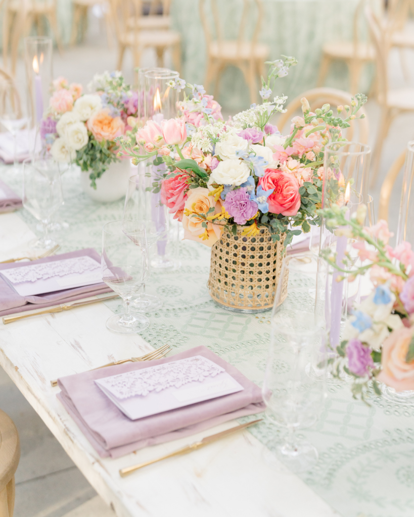 Garden party wedding tablescape with colorful florals, lavender accents, candles, and elegant place settings at The VanLandingham Estate.