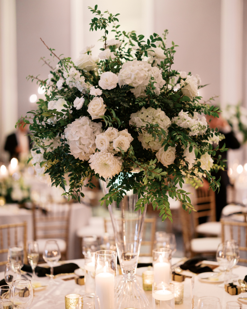 Tall white floral centerpiece featuring hydrangea, roses, and greenery at an elegant Charlotte wedding reception.