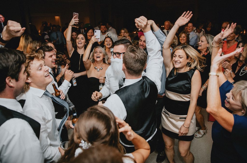 Guests celebrating on a packed dance floor during a lively wedding reception in Columbus, Ohio.