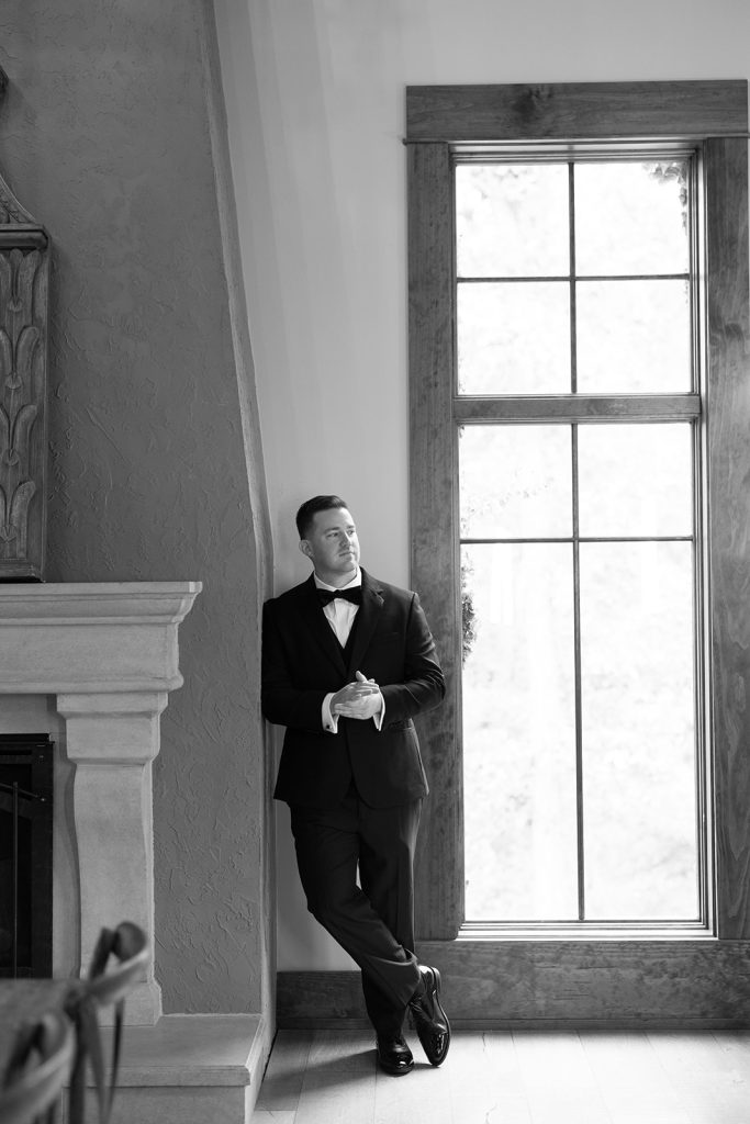Groom posing in the Groom's Quarters at Silver Oaks Chateau.