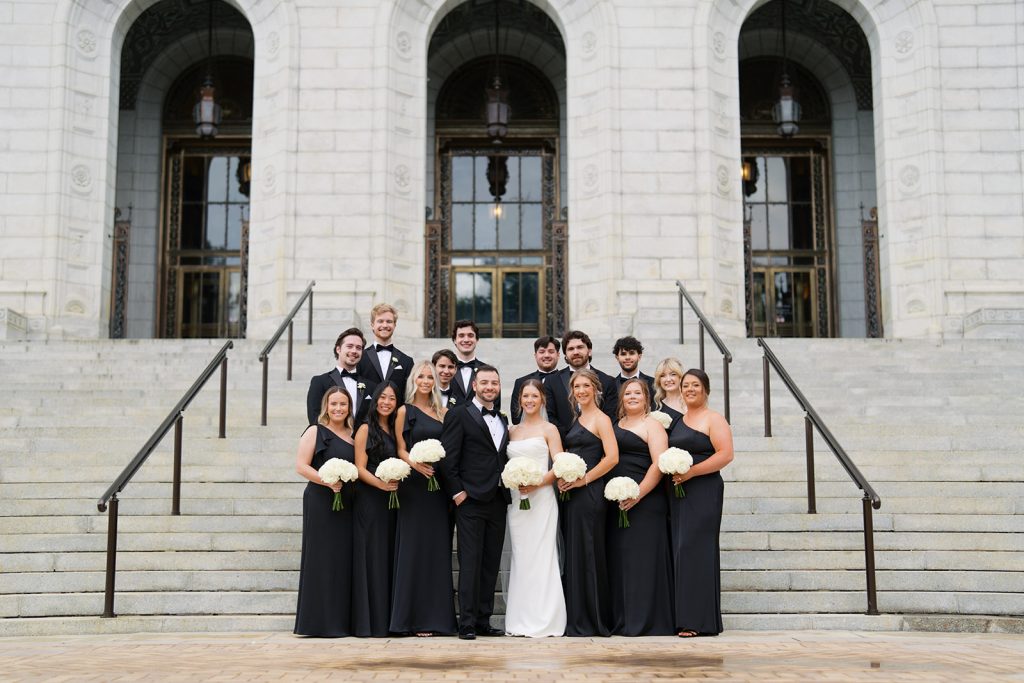 Wedding party standing on the steps at the St. Louis Public library.