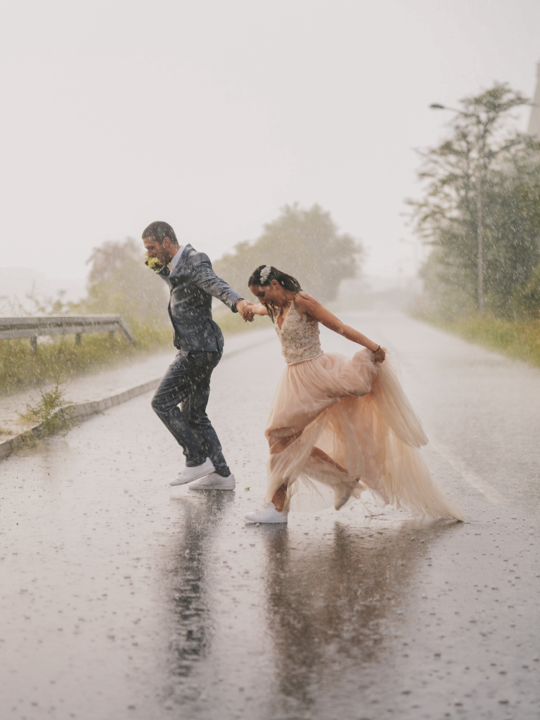 couple running on the street in the rain