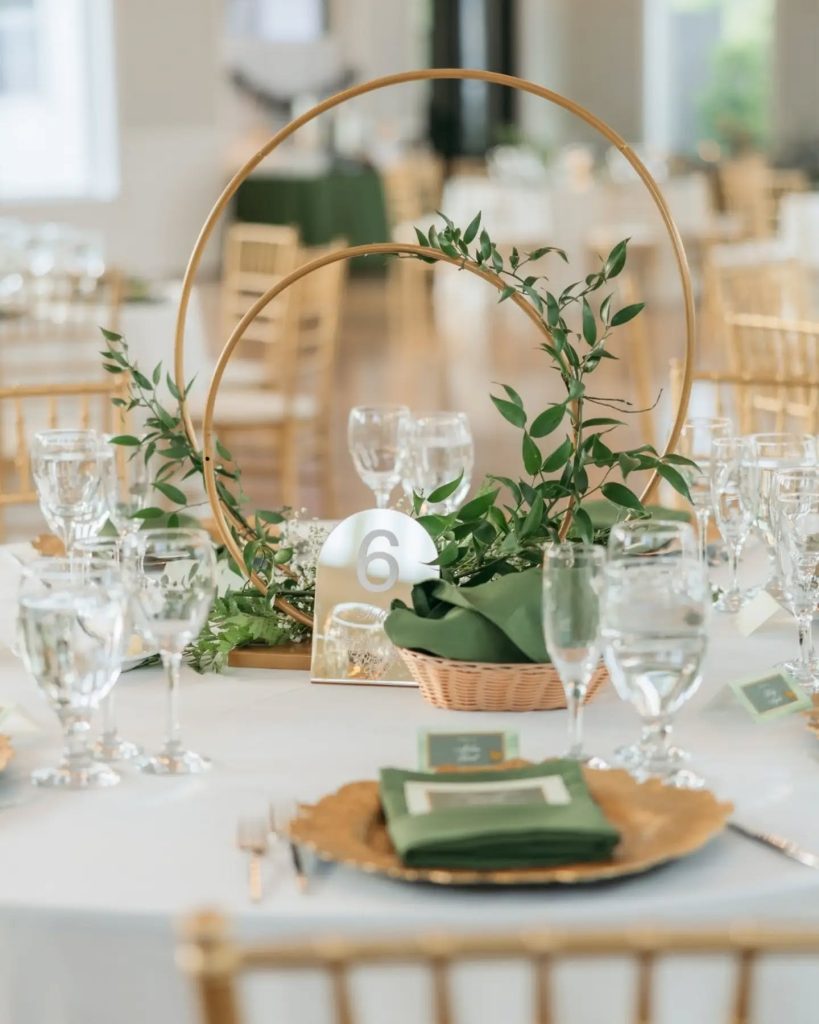 wedding reception tablescape with gold details and greenery
