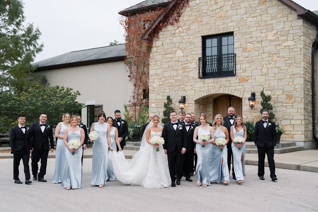 Bridal party walking outside the French-inspired Silver Oaks Chateau wedding venue.