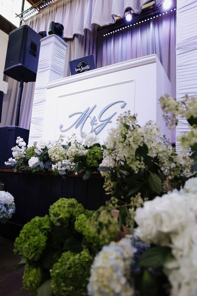 Custom wedding DJ booth featuring bride and groom's monogram created by Spin Society DJs.