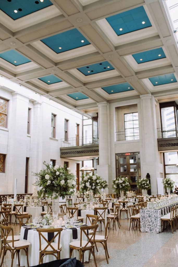 Elegant wedding reception designed and coordinated by Vowed Weddings at the Ohio Statehouse in Columbus, Ohio, featuring tall floral centerpieces and timeless reception décor.