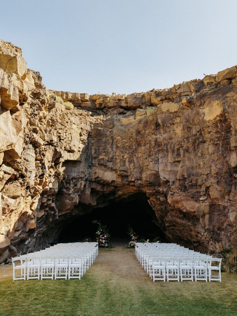 white garden folding chairs set up for wedding ceremony at Juniper Preserve