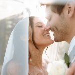 Creative wedding photography inspiration featuring a romantic bride and groom close-up portrait underneath the bridal veil.