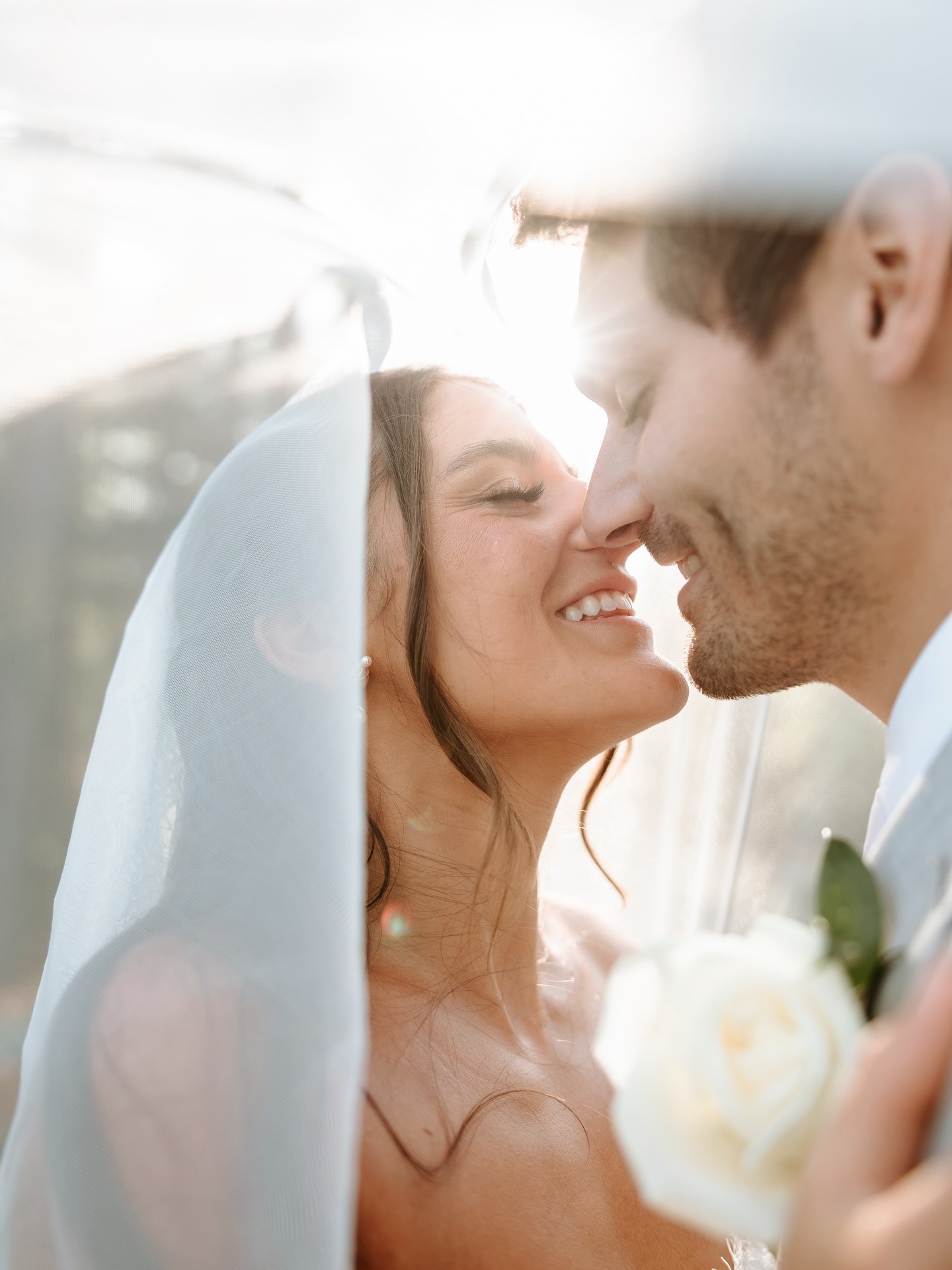 Creative wedding photography inspiration featuring a romantic bride and groom close-up portrait underneath the bridal veil.