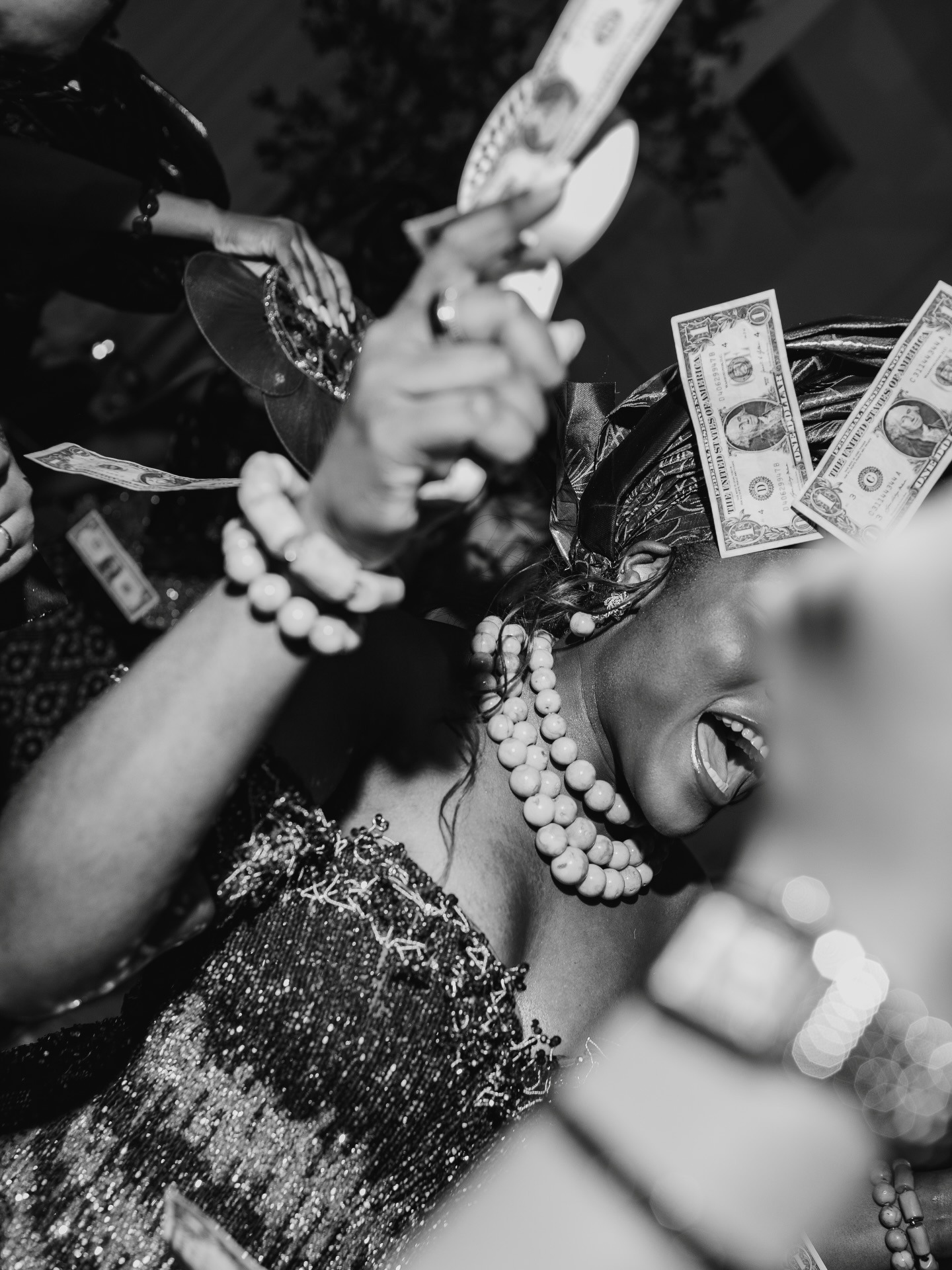 Cultural wedding inspiration showing a bride in traditional attire during a lively wedding reception money spray dance.
