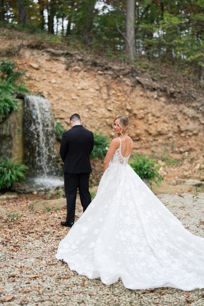 Bride and groom preparing for their first look in front of the waterfall at Silver Oaks Chateau.