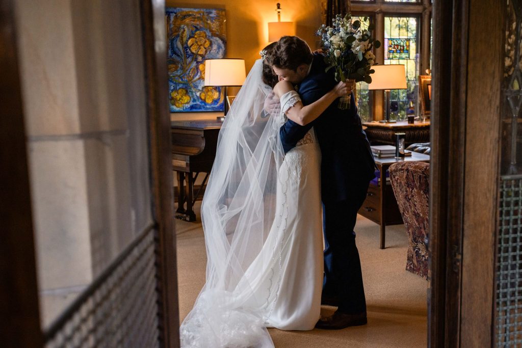 Bride and groom embracing in a historic Columbus venue during a private moment on their wedding day.